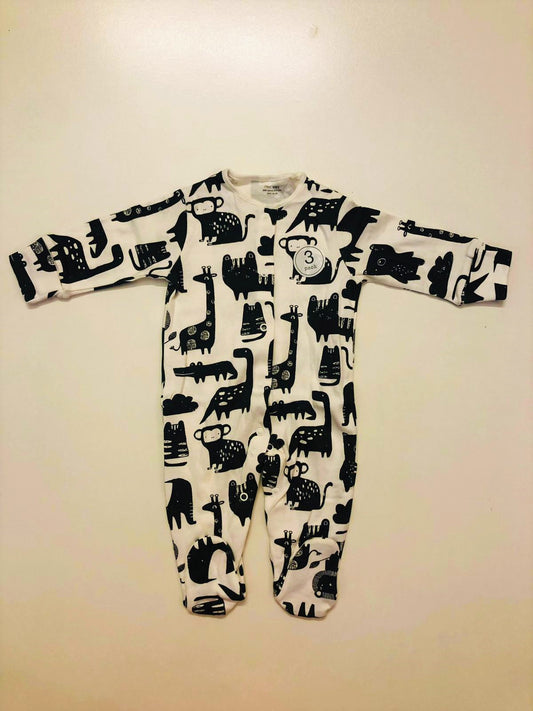 Black animals on white sleepsuit