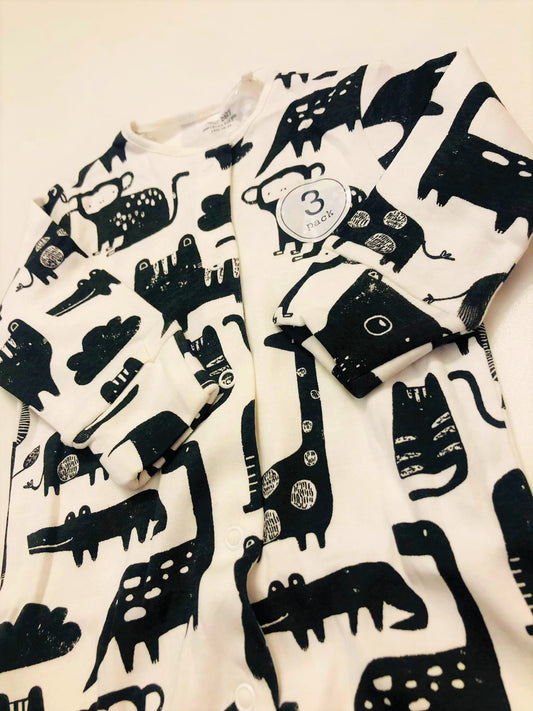 Black animals on white sleepsuit