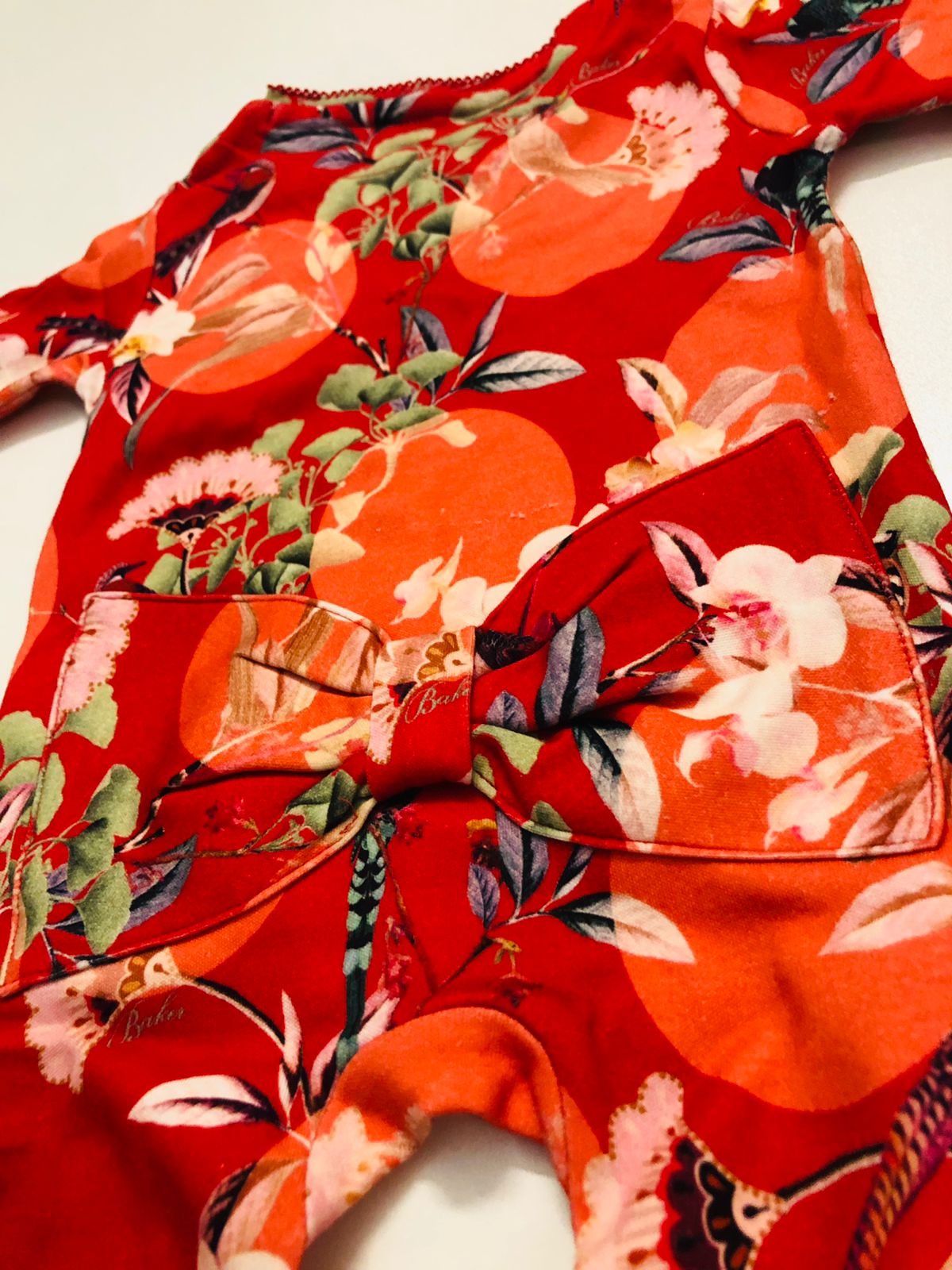 Flower pattern on red sleepsuit 4.5kg